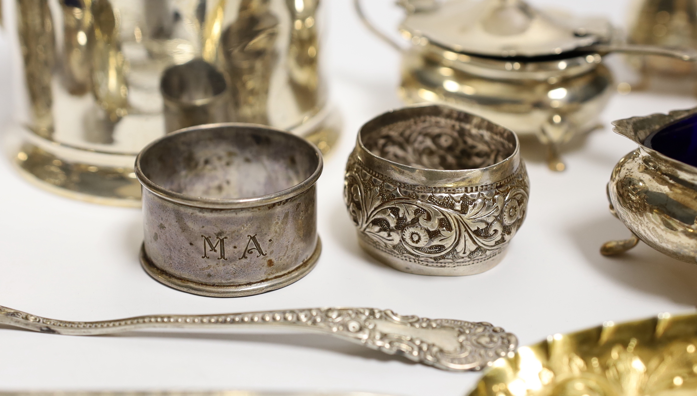 A George VI silver mug, Birmingham, 1937, 11.5cm with engraved inscription to Wing Commander E.E.M Angell, a pair of George III Old English pattern berry spoons, a George IV silver caddy spoons and other items including